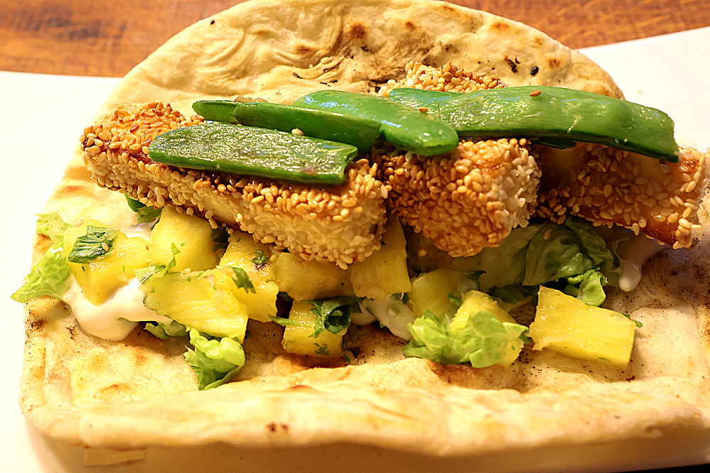 Fladenbrot mit Ananasrelish, Sesam panierten Paneer-Sticks und gebratenen Zuckerschoten gefüllt