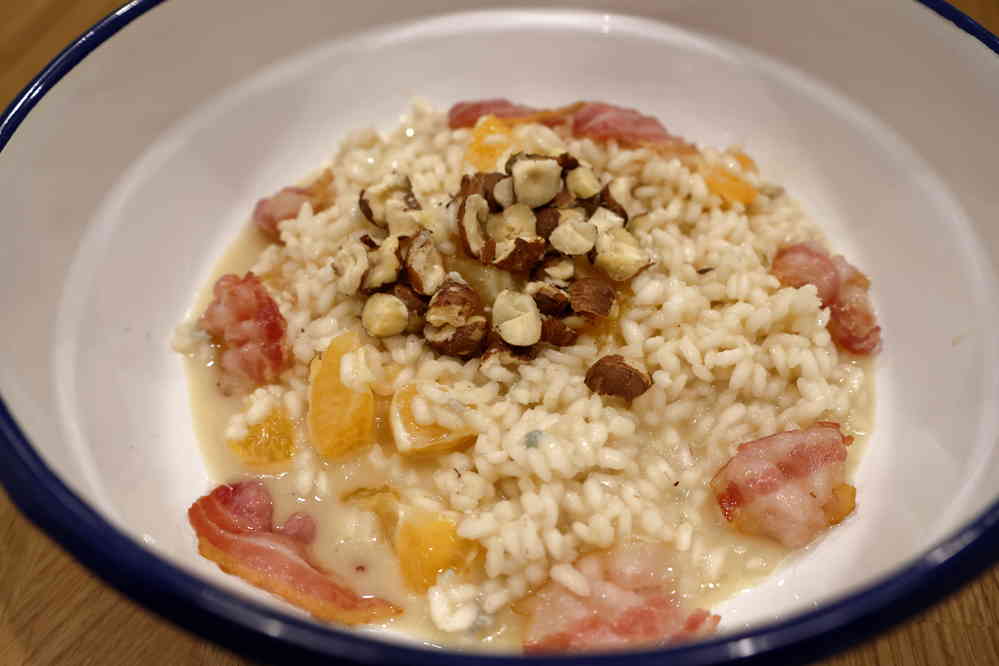 cremiger Gorgonzolarisott mit Mandarinenstückchen, Haselnüssen und Speck
